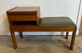 A Mid Century Chippy telephone table upholstered in faux green leather