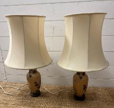 A pair of ceramic table lamps decorative with tree blossom
