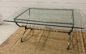 A wrought iron glass topped coffee table with twisted central stretcher (H50cm W110cm D77cm)