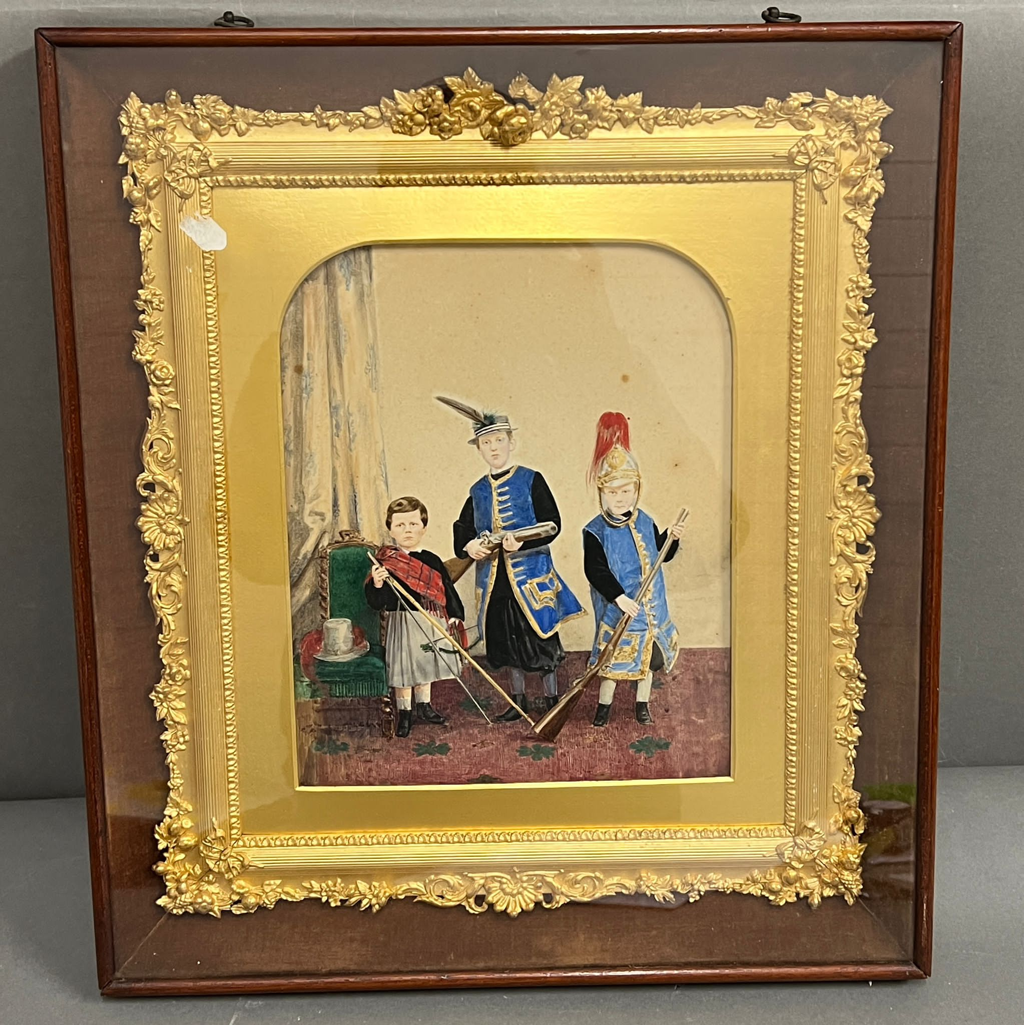 A water colour of children playing in a gilt frame incased 32cm x 38cm