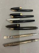 Three Shaeffer fountain pens, one Swan fountain pen and two white metal propelling pencil and ball