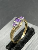 An amethyst and diamond ring, central oval cut amethyst weighing an estimated 0.16ct with three