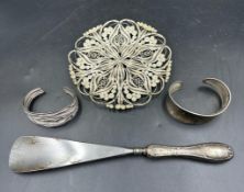 A selection of silver items to include two bangles and silver handled shoehorn and a filigree silver