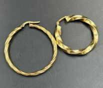 Two mismatched 9ct gold earrings in a loop style.