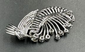 A white gold diamond spray brooch with a beautiful array of quality diamonds.