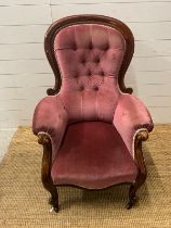 A Victorian arm chair with button back