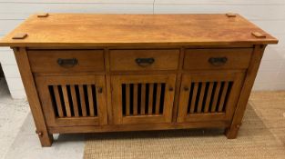 A hardwood sideboard with three drawers and three cupboards under (H80cm W150cm D45cm)