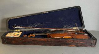 A violin in a rosewood case, new strings and hairs needed for bow and violin.