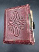 A red leather Victorian photograph album with contents