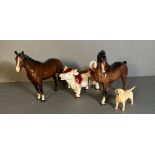 A selection of three Beswick figures and a cow creamer