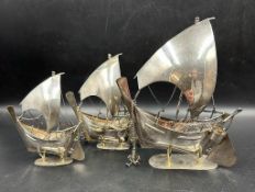 A set of three sterling silver Dow boats on stands, approx total weight 375g
