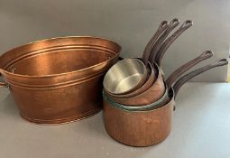 A set of five copper pans and one metal two handle bucket