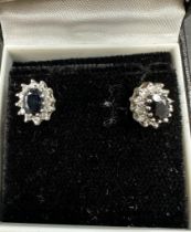 A Pair of diamond and sapphire earrings.