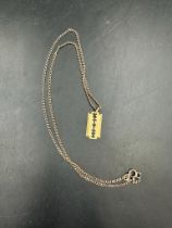 An 18ct gold razor blade pendant on a 9ct gold necklace (1.7ct and 4.3ct)