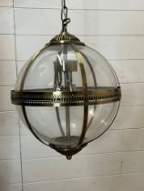 A pair of antique brass style clear glass pendants