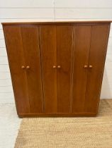 A Mid Century teak Clerical cabinet comprising of three cupboards and multiple shelves (H128cm