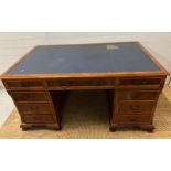 A Pedestal desk with leather top on bracket feet