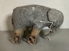A vintage grey toy elephant on wheels