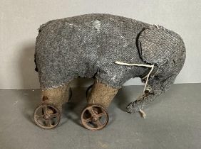 A vintage grey toy elephant on wheels