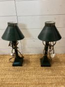 A pair of metal lamp with pieced cut out to rim