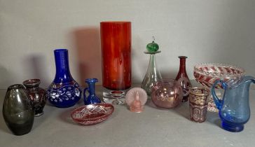 A selection of coloured glass to include vases, jugs and dishes