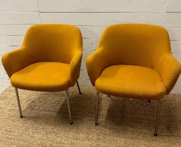 A pair of Mid Century mustard upholstered arm chairs on chrome legs
