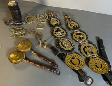 A collection of horse brass along with a novelty lighter in the form of a riding boot and