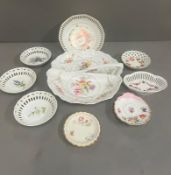 A selection of decorative pierced dishes and handled serving plate. All with a floral or fruit theme