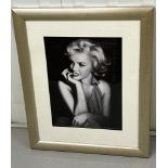 A signed photograph in the style of Marilyn Monroe. (52cm x 66cm)