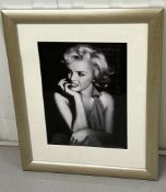 A signed photograph in the style of Marilyn Monroe. (52cm x 66cm)