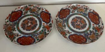 A pair of Chinese plates with blue character marks to base. Diameter 23cm