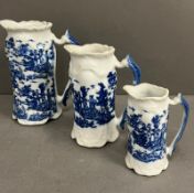 Three graduating blue and white china jugs, stamped to base