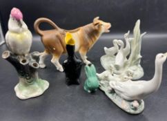 A selection of ceramic animals to include Lladro Geese and a cow creamer