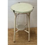 A white Lloyds loom style side table with glass top (H71cm Dia38cm)