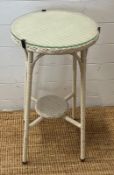 A white Lloyds loom style side table with glass top (H71cm Dia38cm)
