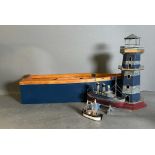 A selection of maritime models. Three boats and a lighthouse