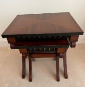 A pair of nesting reproduction tables on cross supports (H44cm E45cm D36cm)