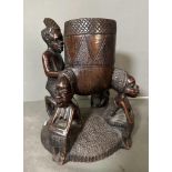 A Heavy East African carved pot on stand. 32cm H