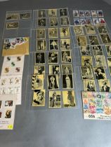 A small selection of cigarette cards and stamps.
