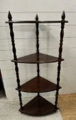 A mahogany four tier corner stand on turned supports (H110cm D30cm W50cm)