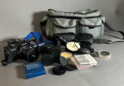 A Chinon CG-5 35mm camera, bag and additional equipment