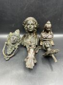 A selection of cast iron figures and door knockers to include a bust of Queen Victoria.