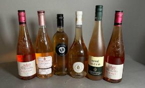 A selection of six bottles of rose wine, various styles, makers and years.