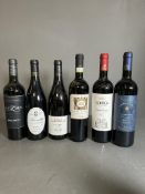 A selection of six bottles of red wine, various styles, makers and years.