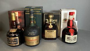 Four Bottles of Spirits: Grand Marnier, Courvoisier, Grand Marnier, Hine Antique.