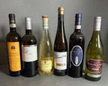 A selection of six bottles of white wine, various styles, makers and years.