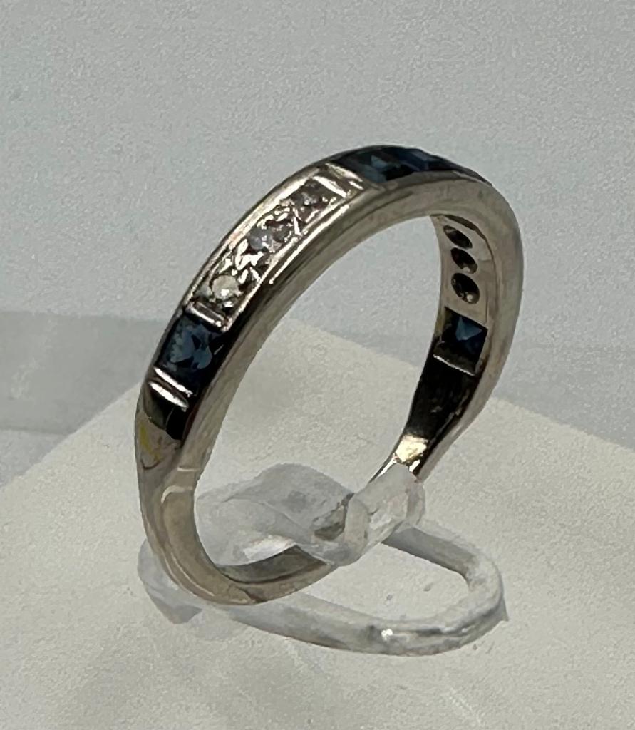 A diamond and sapphire, half eternity style ring set in 18ct white gold, approximate size M