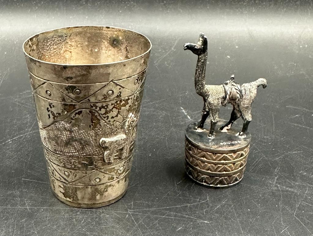 Two silver curios marked 925, a camel on plinth and a beaker