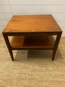 A Mid Century teak side table on tapering legs and shelf under (H48cm W61cm D54cm)