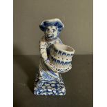 A Delft blue and white salt of a monkey, dresses as a maid holding a bucket Condition Report some